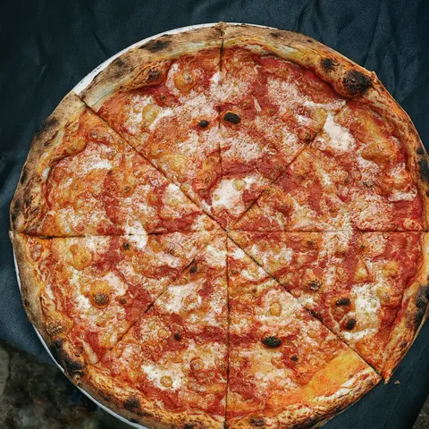 burnt. new york style cheese pizza, sliced, top view